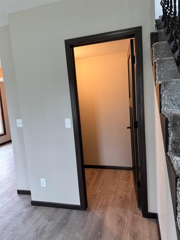 305 E 5th St, Vinton, IA 52349 - corridor with wood finished floors and baseboards