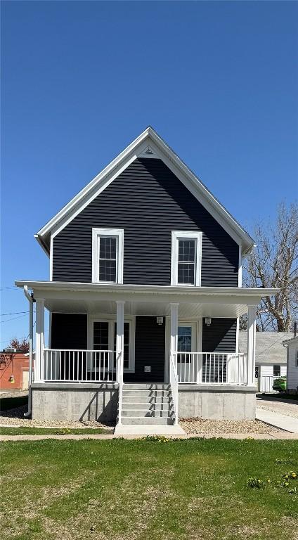 305 E 5th St, Vinton, IA 52349 - view of front of home with a porch and a front yard