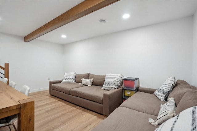 living room featuring light wood-type flooring, recessed lighting, beamed ceiling, and baseboards