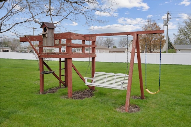 view of play area featuring fence and a lawn