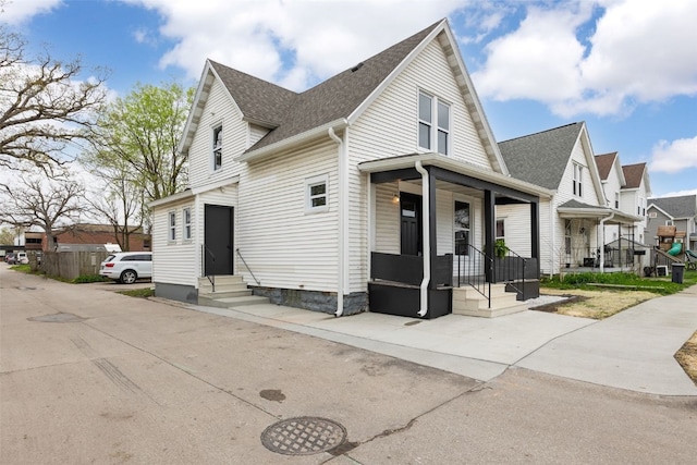 317 16th St NE, Cedar Rapids, IA 52402 - view of property exterior featuring entry steps, roof with shingles, a residential view, and covered porch