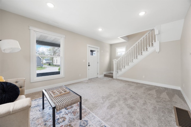 317 16th St NE, Cedar Rapids, IA 52402 - living area featuring stairs, healthy amount of natural light, carpet floors, baseboards, and recessed lighting