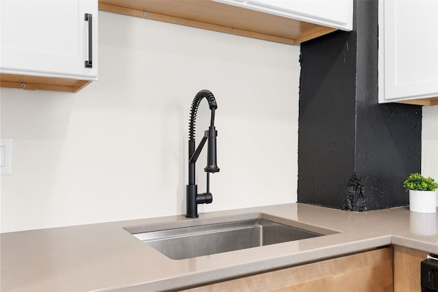 317 16th St NE, Cedar Rapids, IA 52402 - kitchen view of a sink, white cabinets, and light countertops