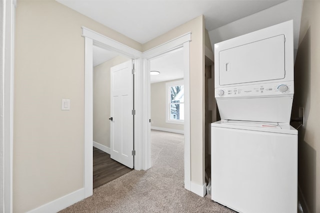 317 16th St NE, Cedar Rapids, IA 52402 - washroom with stacked washer / drying machine, carpet, and baseboards