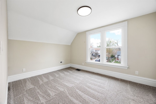 317 16th St NE, Cedar Rapids, IA 52402 - additional living space with baseboards, carpet, and vaulted ceiling