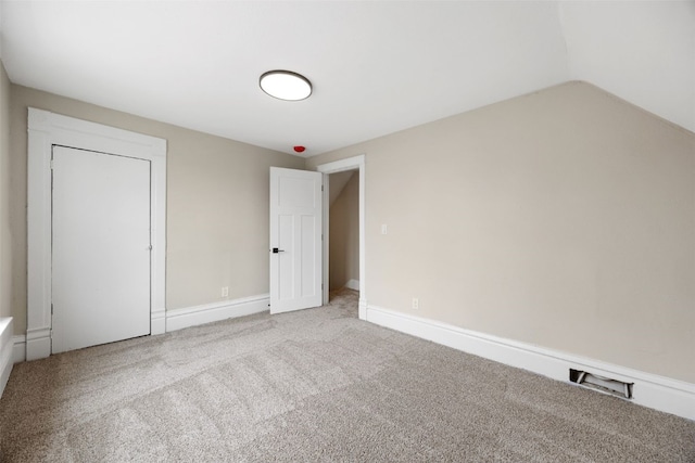 317 16th St NE, Cedar Rapids, IA 52402 - unfurnished bedroom featuring carpet flooring, lofted ceiling, and baseboards