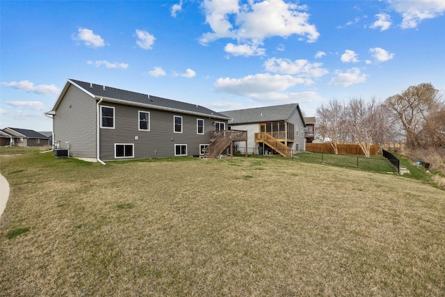 5116 Ruhd St SW, Cedar Rapids, IA 52404 - rear view of house featuring a wooden deck, fence, central AC unit, a yard, and stairway
