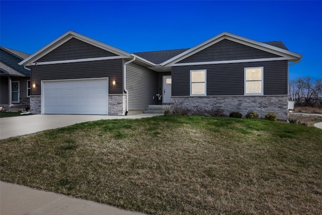 5116 Ruhd St SW, Cedar Rapids, IA 52404 - view of front facade with stone siding, driveway, an attached garage, and a front yard