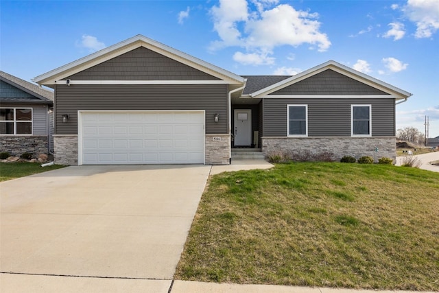5116 Ruhd St SW, Cedar Rapids, IA 52404 - craftsman house featuring an attached garage, a front lawn, driveway, and stone siding