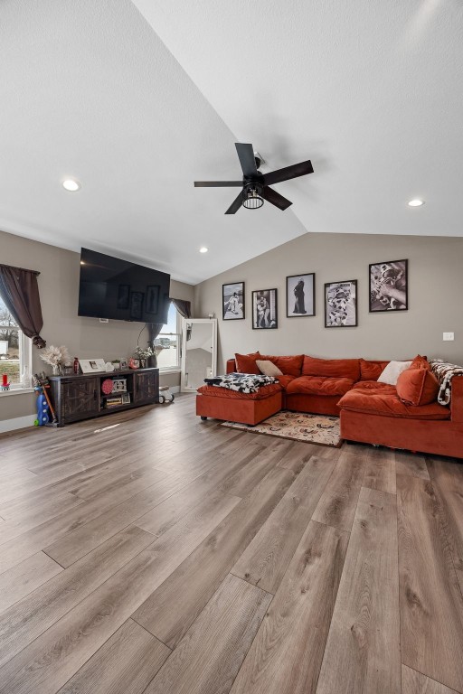 5116 Ruhd St SW, Cedar Rapids, IA 52404 - living room with vaulted ceiling, a ceiling fan, wood finished floors, plenty of natural light, and recessed lighting