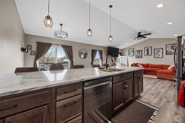 5116 Ruhd St SW, Cedar Rapids, IA 52404 - kitchen featuring light wood-type flooring, a sink, open floor plan, dishwashing machine, and lofted ceiling