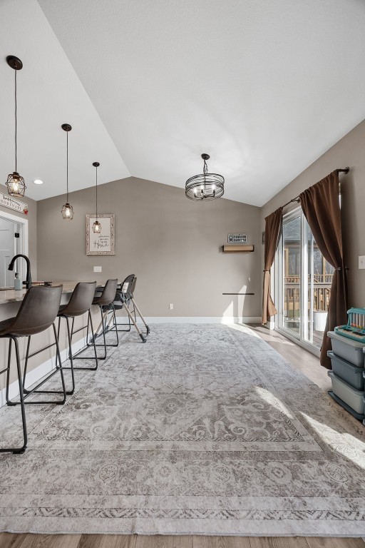 5116 Ruhd St SW, Cedar Rapids, IA 52404 - interior space featuring baseboards, a notable chandelier, and lofted ceiling