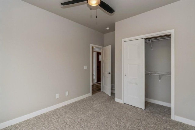 unfurnished bedroom with ceiling fan, baseboards, carpet flooring, and a closet