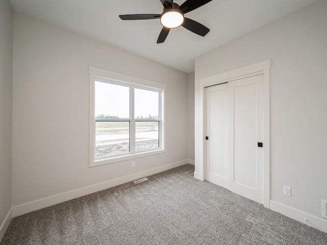 5497 Silver Ridge Rd, Marion, IA 52302 - unfurnished bedroom with carpet floors, baseboards, visible vents, and a closet
