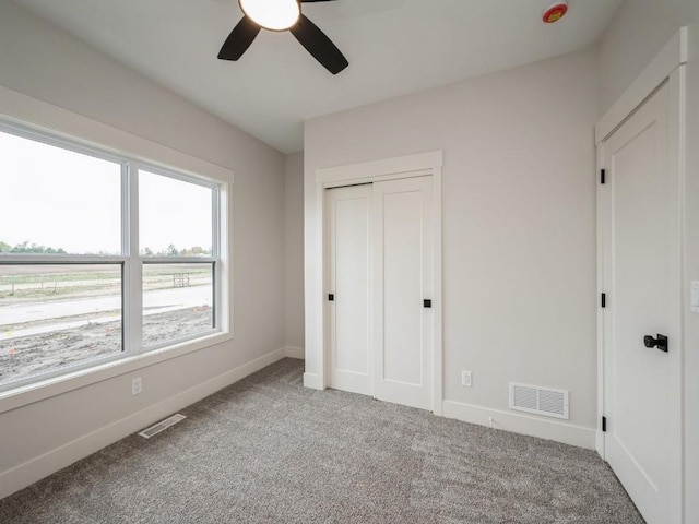 5497 Silver Ridge Rd, Marion, IA 52302 - unfurnished bedroom with baseboards, carpet, a closet, and visible vents