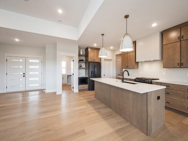 5497 Silver Ridge Rd, Marion, IA 52302 - kitchen featuring decorative backsplash, open shelves, built in microwave, a sink, and black fridge