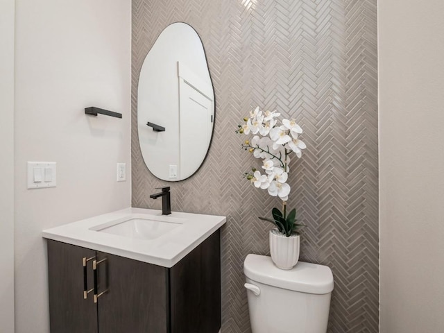 5497 Silver Ridge Rd, Marion, IA 52302 - half bath featuring vanity, toilet, and tile walls
