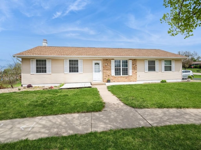 6664 Sand Ct SW, Cedar Rapids, IA 52404 - ranch-style home with a chimney and a front lawn