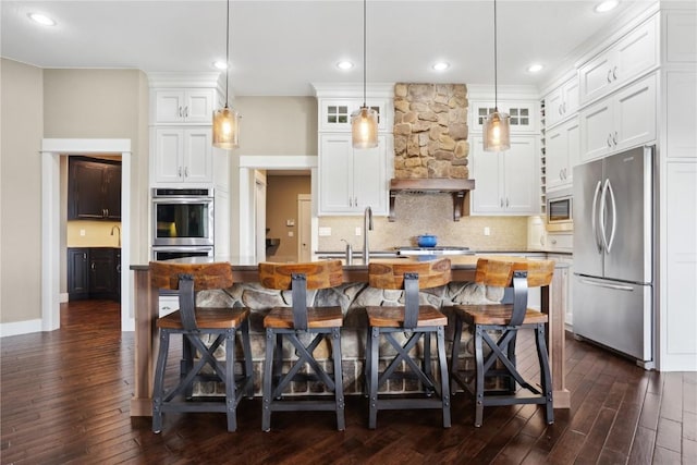kitchen featuring white cabinets, glass insert cabinets, a sink, stainless steel appliances, and dark wood-style flooring