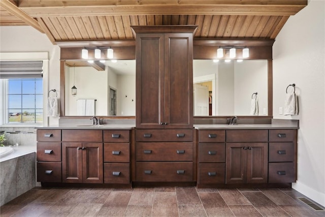 full bathroom with visible vents, a bathtub, vanity, and wood ceiling