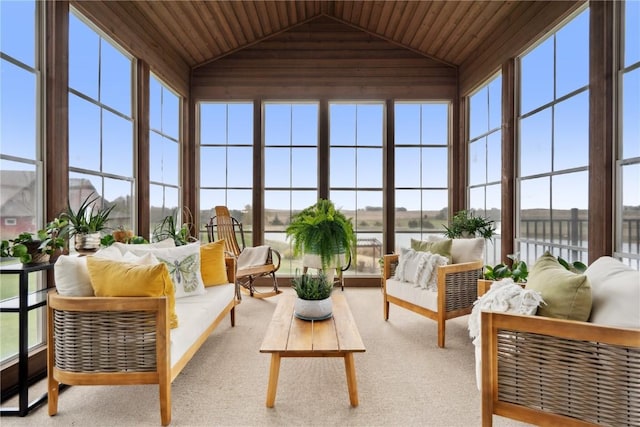 sunroom / solarium with vaulted ceiling, plenty of natural light, a water view, and wood ceiling