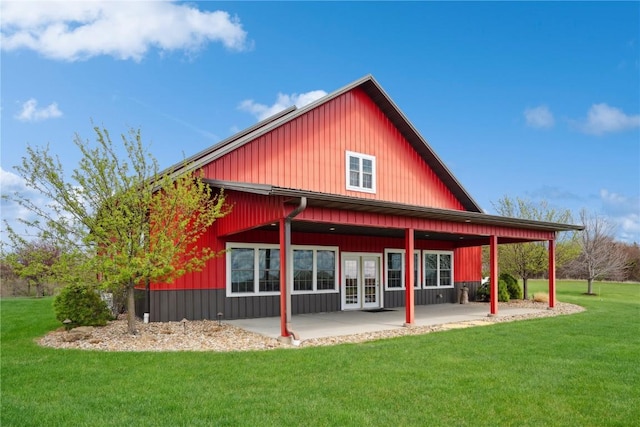 rear view of property with a yard and a patio area