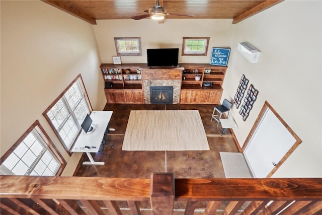 living room featuring wood ceiling, ceiling fan, a lit fireplace, and dark wood-style floors