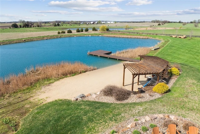 exterior space with a dock, a water view, and a lawn