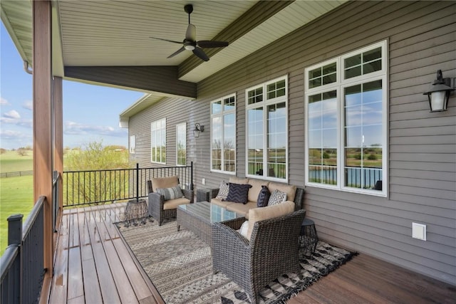 wooden deck featuring outdoor lounge area and a ceiling fan