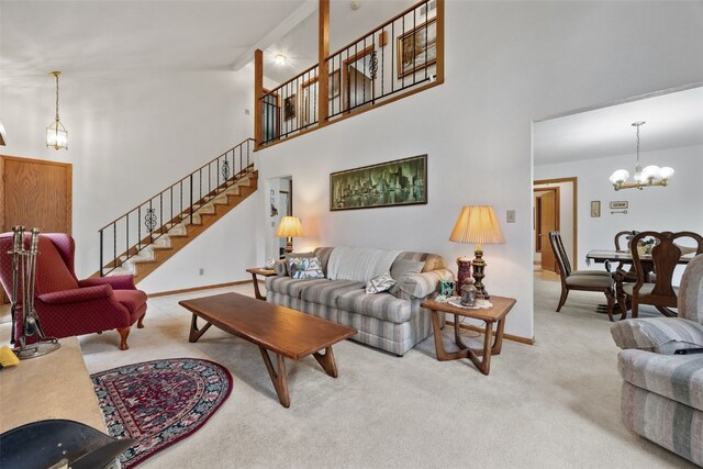 5823 Timber Creek Rd, Cedar Rapids, IA 52411 - carpeted living area with high vaulted ceiling, a chandelier, baseboards, and stairway