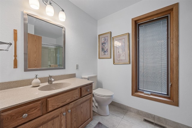 5823 Timber Creek Rd, Cedar Rapids, IA 52411 - bathroom with a shower with shower door, tile patterned flooring, vanity, toilet, and visible vents