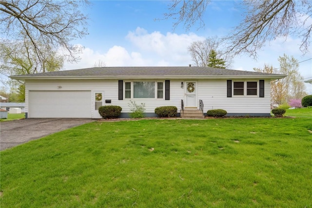 ranch-style house featuring an attached garage, driveway, and a front lawn