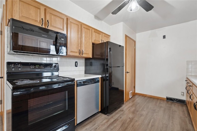 kitchen featuring light wood-style floors, ceiling fan, light countertops, backsplash, and black appliances