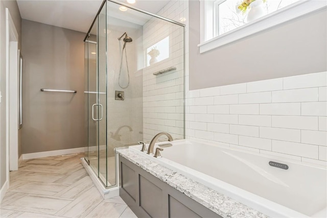 full bath featuring a shower stall and a garden tub