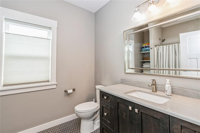 full bathroom with vanity, curtained shower, toilet, baseboards, and tile patterned floors