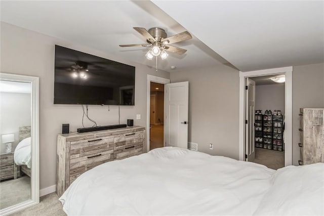 bedroom with baseboards, light carpet, and a ceiling fan