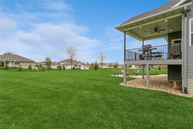 view of yard featuring ceiling fan and a residential view