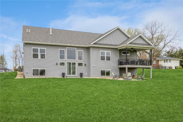 rear view of house with roof with shingles, a ceiling fan, a patio area, central air condition unit, and a yard