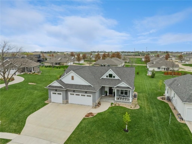 view of front facade featuring a porch, a residential view, a shingled roof, and a garage