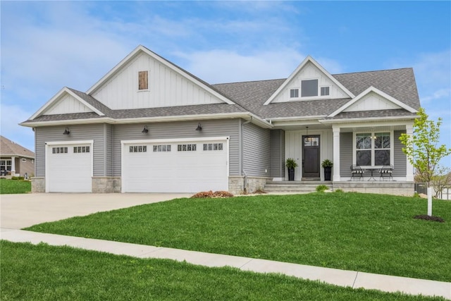 craftsman-style house featuring an attached garage, board and batten siding, a front yard, and concrete driveway