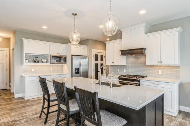 kitchen featuring a sink, appliances with stainless steel finishes, white cabinets, and tasteful backsplash