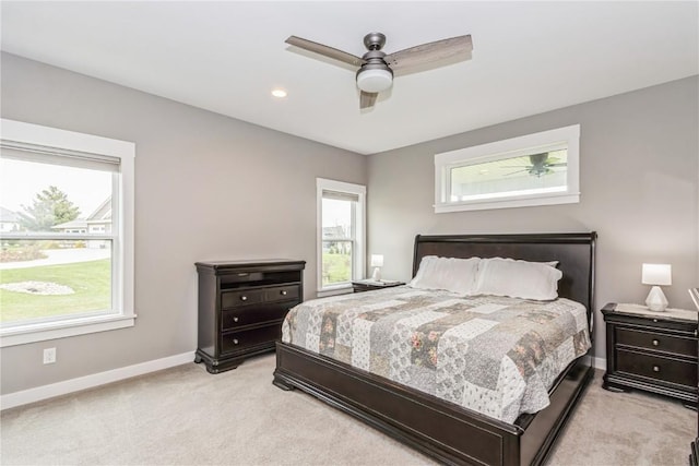 bedroom featuring baseboards, ceiling fan, and light carpet