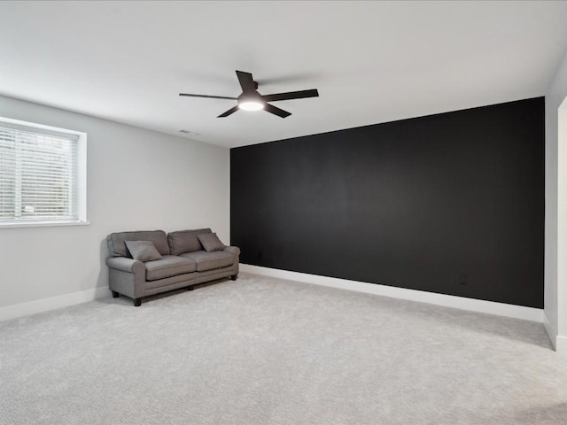 unfurnished room with baseboards, ceiling fan, visible vents, and light carpet