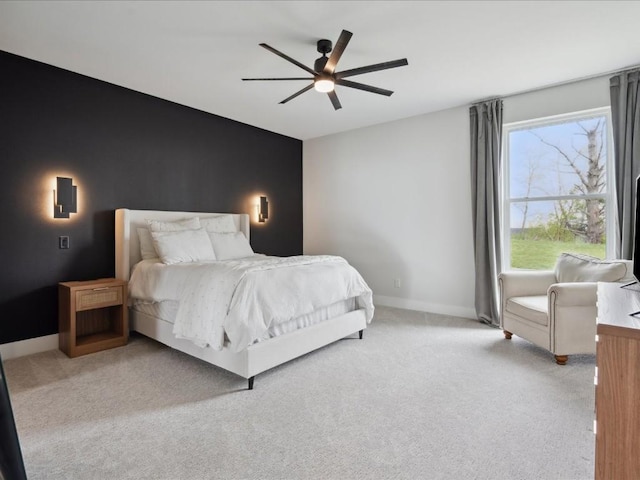 bedroom with ceiling fan, light colored carpet, and baseboards