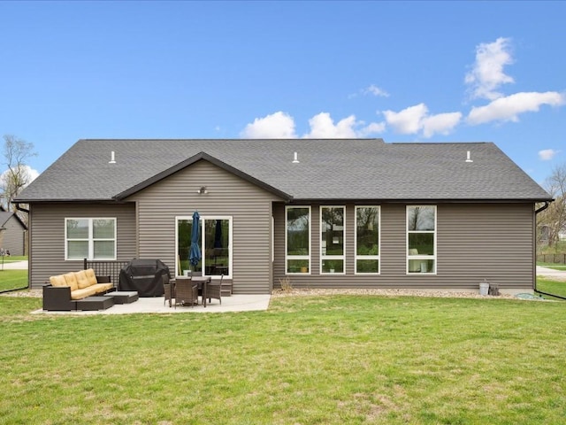 back of property with a yard, a patio, a shingled roof, and an outdoor living space