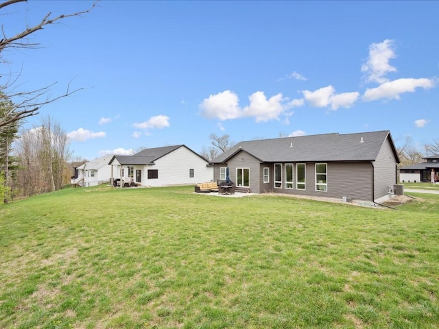 rear view of house featuring a yard and a patio