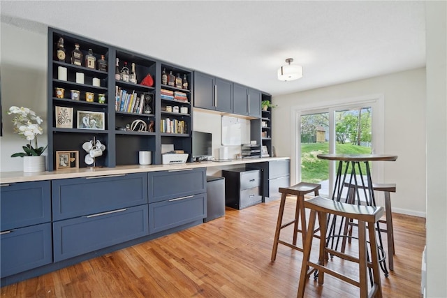 office area featuring baseboards and light wood finished floors