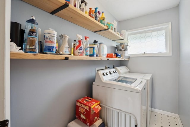 laundry area featuring baseboards, laundry area, tile patterned floors, and washer and dryer