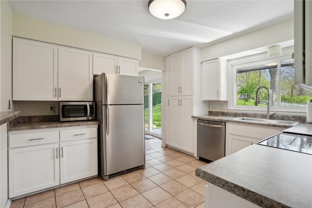 kitchen featuring a sink, white cabinetry, appliances with stainless steel finishes, and a wealth of natural light