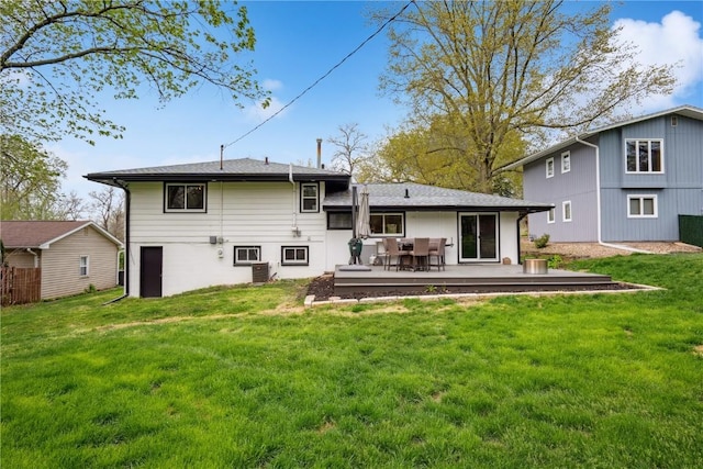 back of house with a lawn and a deck